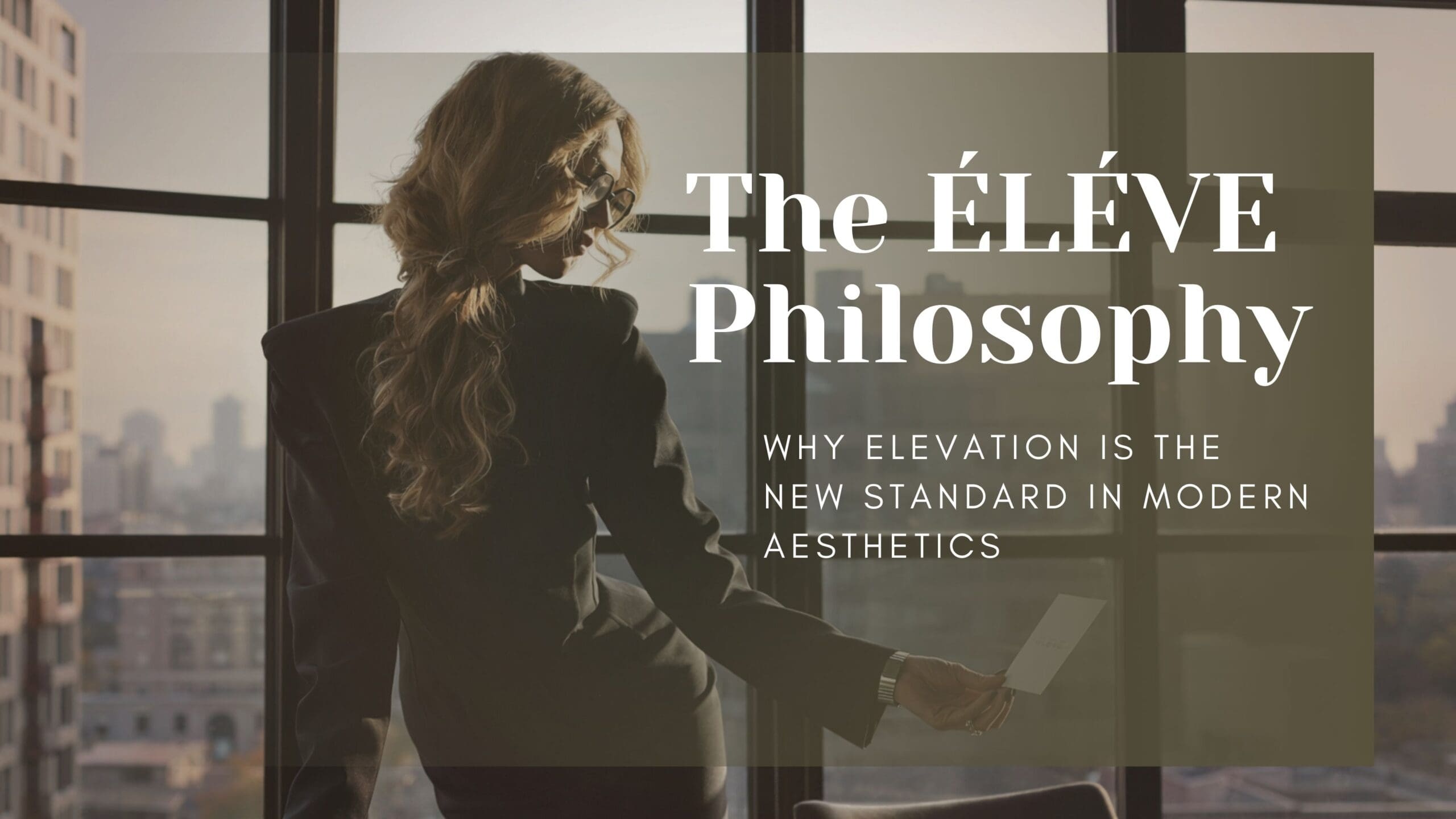 Woman standing in a refined interior holding a card, symbolizing the Élevé philosophy and elevated standards in aesthetics.